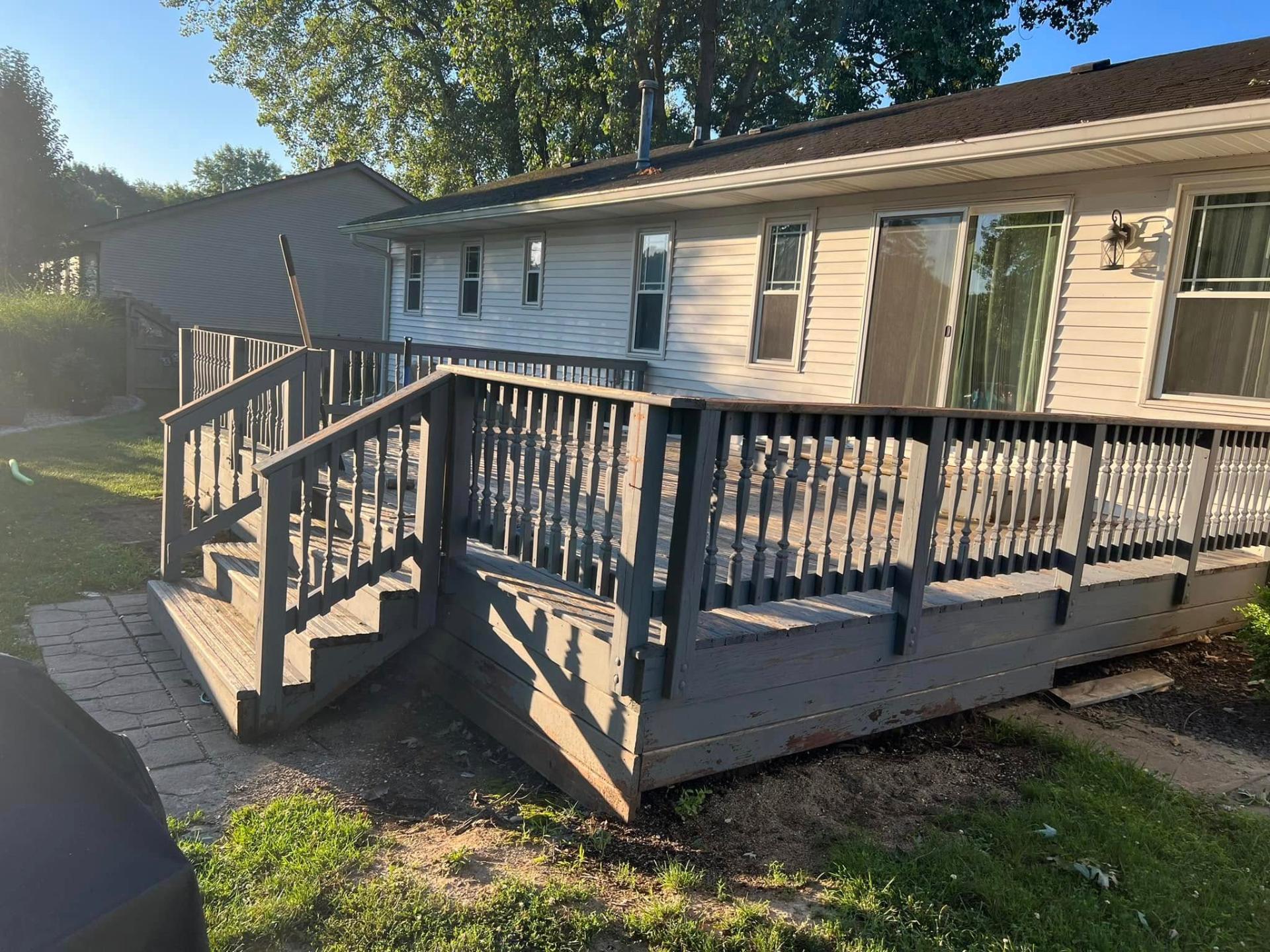 Old rotted grey wooden deck before rebuild
